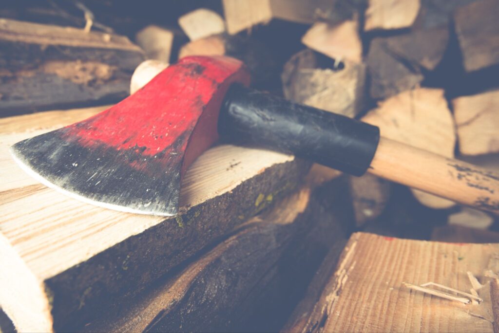 Axe lying on a pile of cut wood.