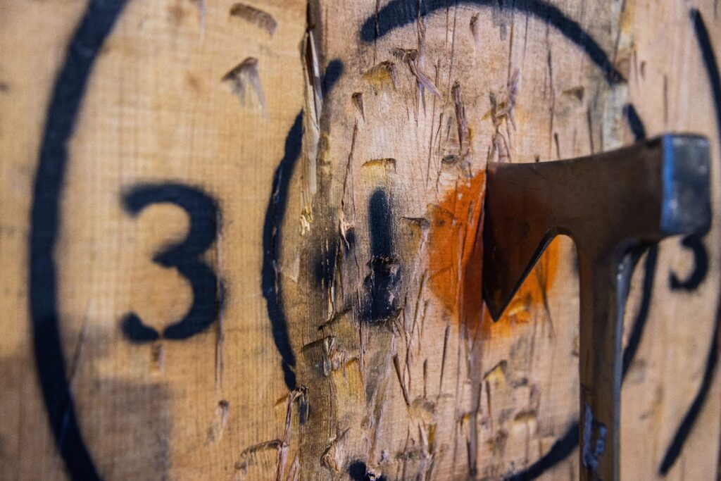 An axe has hit the bullseye of an axe-throwing target.