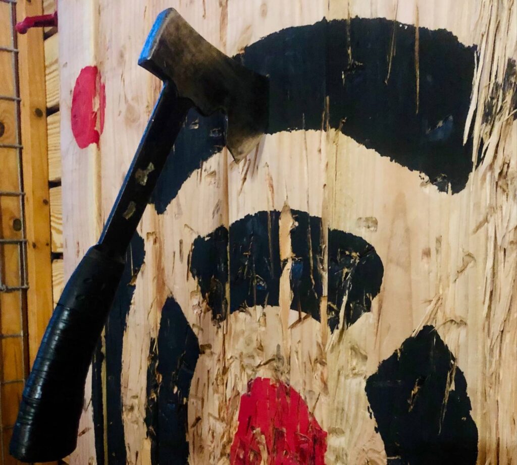 Axe sticking out of a wood target.