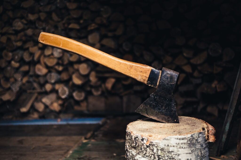 Axe lodged into a piece of wood.