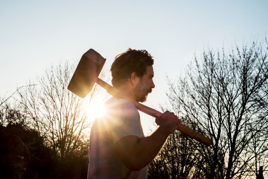 bearded-man-walking-outdoors-at-sunset-carrying-l-2023-11-27-05-11-58-utc