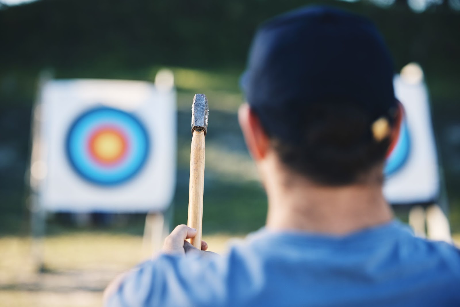 A man about to throw an axe to a target.